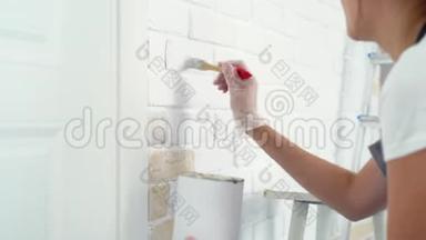 女人的手`用一面刷砖<strong>墙画</strong>的特写